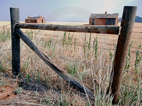 TWO RUINS & FENCE IN APPROACHING STORM (Western OK)