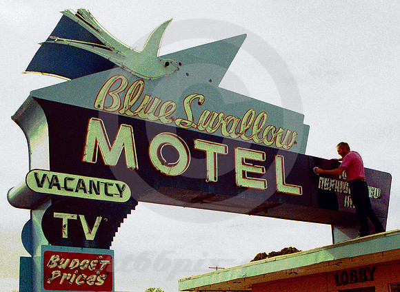WAXING THE BLUE SWALLOW SIGN (Rt 66 Tucumcari NM)